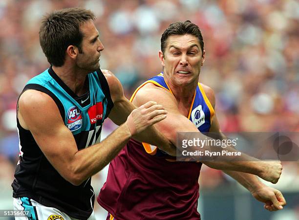 Alastair Lynch of the Lions clashes with Darryl Wakelin of the Power during the AFL Grand Final between the Port Adelaide Power and the Brisbane...