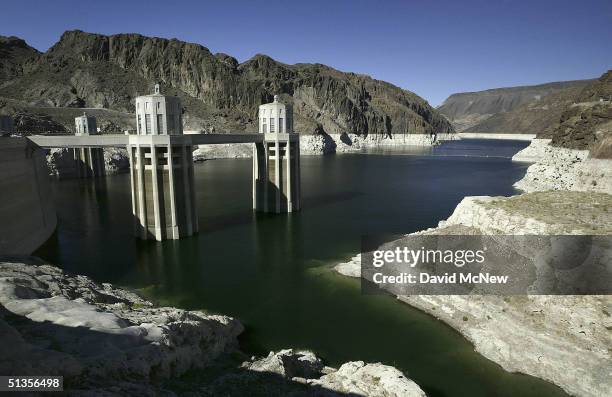 White "bathtub ring" encircles Lake Mead near the 395-foot-tall intake towers of Hoover Dam as the lake continues falling to historic low levels on...