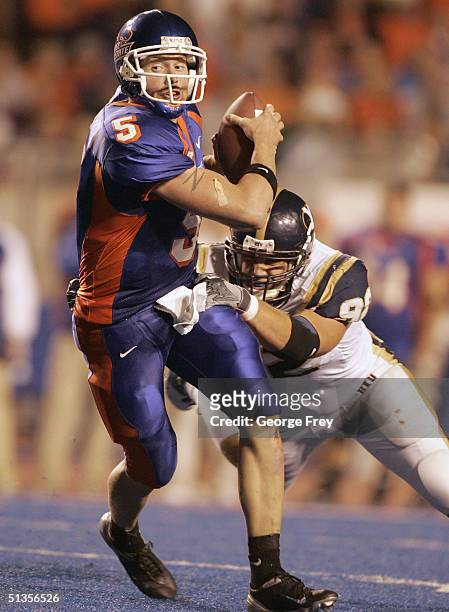 Jared Zabransky quarterback of Boise State scrambles out of a tackle by John Denney of BYU September 24, 2004 at Broncos Stadium in Boise, Idaho. BSU...