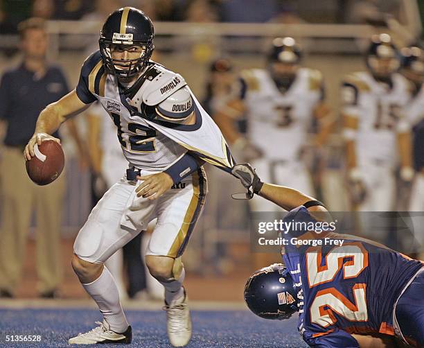 Korey Hall of Boise State holds on and sacks John Beck of BYU September 24, 2004 at Broncos Stadium in Boise, Idaho. BSU won the game over BYU 28-27.