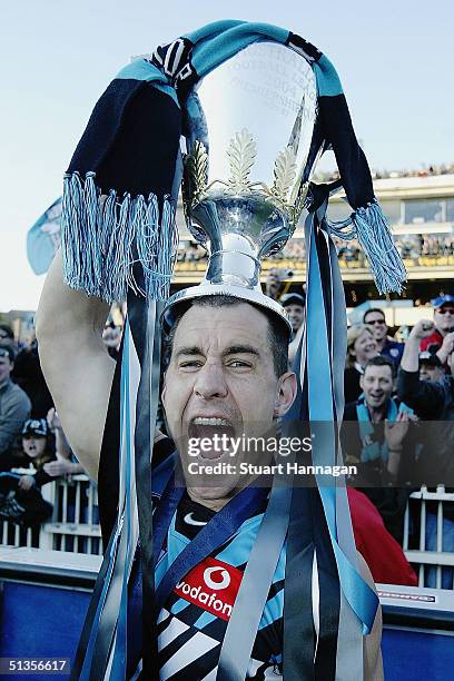 Warren Tredrea of Port Power celebrates with the trophy after the AFL Grand Final between the Brisbane Lions and Port Adelaide Power at the Melbourne...