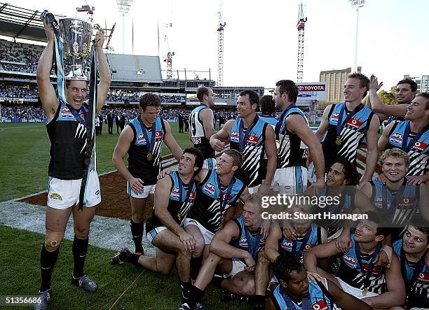 Warren Tredrea holds aloft the cup in front of the team after the AFL Grand Final between the Brisbane Lions and Port Adelaide Power at the Melbourne...