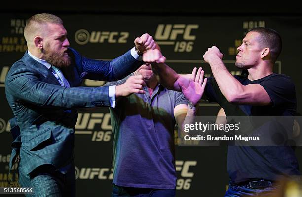 Featherweight champion Conor McGregor throws a punch towards Nate Diaz during the UFC 196 Press Conference at David Copperfield Theater in the MGM...