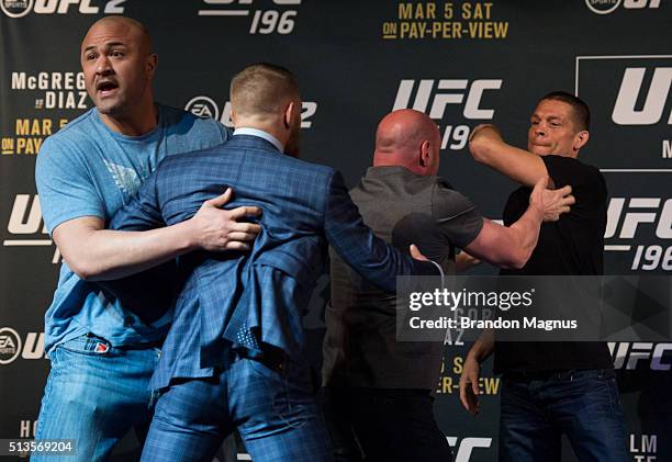 Featherweight champion Conor McGregor and Nate Diaz are separated during the UFC 196 Press Conference at David Copperfield Theater in the MGM Grand...