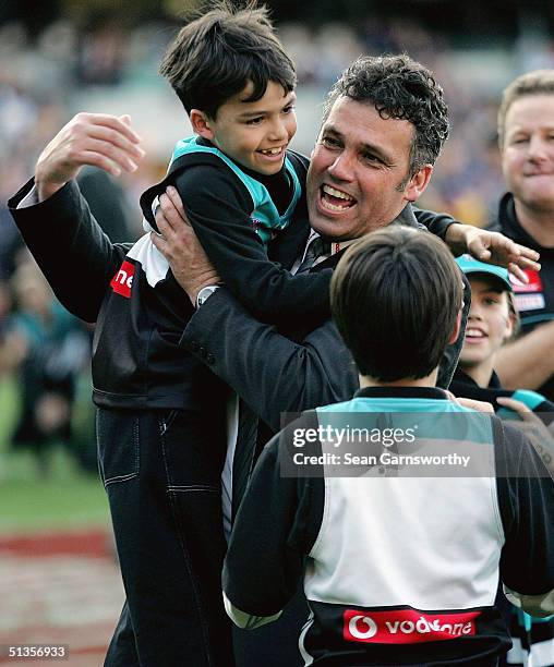 Port Adelaide coach Mark Williams celebrates winning the AFL Grand Final between the Port Adelaide Power and the Brisbane Lions with his children at...