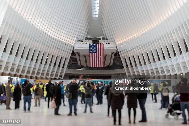 Image was created using a variable planed lens.) Visitors stand inside the World Trade Center transit hub in New York, U.S., on Thursday, March 3,...