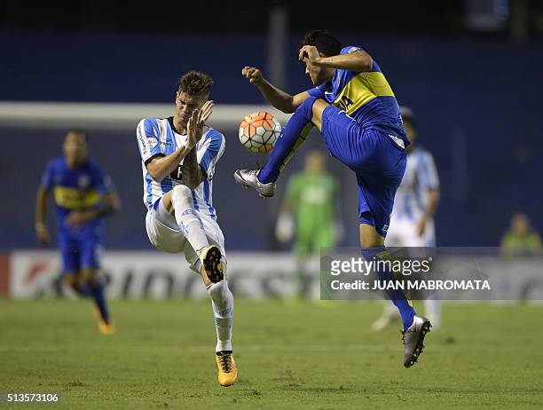 Argentina's Racing Club midfielder Rodrigo De Paul vies for the ball with Argentina's Boca Juniors defender Jonathan Silva during the Copa...