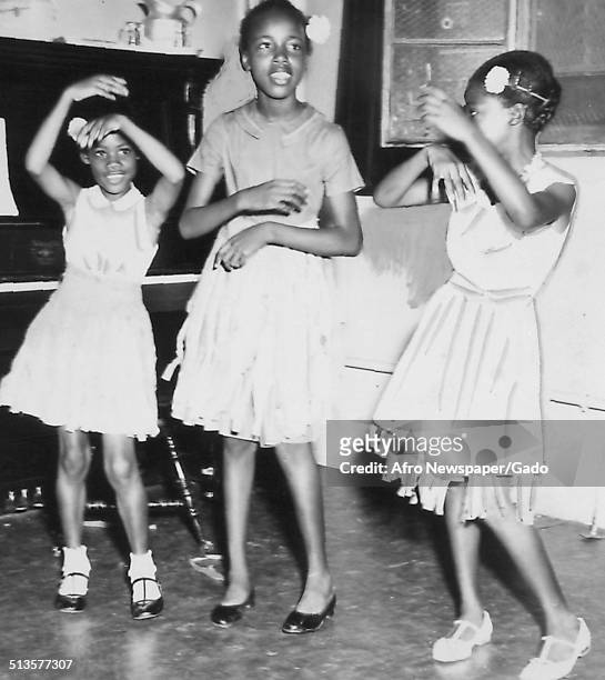 Bernadette Matthews, Jennifer Jones, Gladys Ridall and African American schoolchildren during a talent show, August 23, 1959.