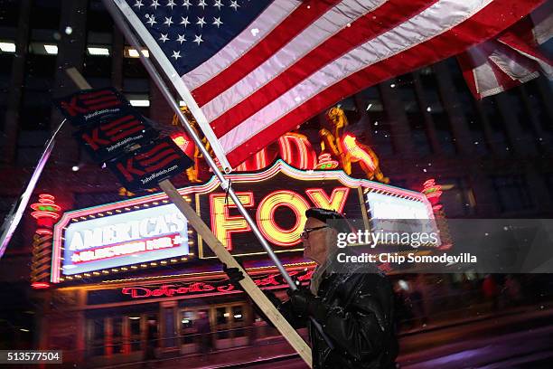 Lone supporter of Republican presidential candidate Ohio Gov. John Kasich marches the historic Fox Theatre before the GOP presidential debate March...