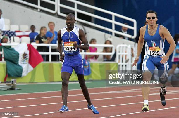 France's Clavel Kayitare and Italy's Stefano Lippi run in the 200m -T42 Men, during teh Paraolympics at the Olympic stadium in the Athens sports...