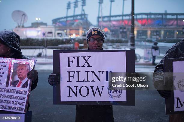 Demonstrators protest outside the Fox Theatre before the start of the Republican presidential debate sponsored by Fox News on March 3, 2016 in...