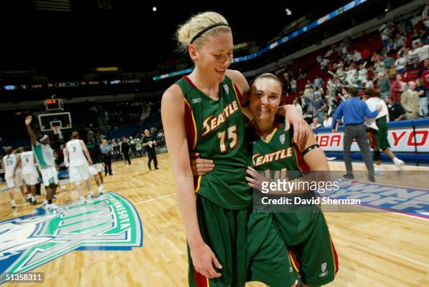 Lauren Jackson and Tully Bevilaqua of the Seattle Storm walk off court after defeating the Minnesota Lynx in game 1 of the 2004 Western Conference...
