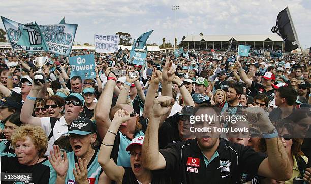 Port Adelaide supporters cheer their team at the welcome home celebration for its victorious premiership team at Alberton Oval on September 26 in...