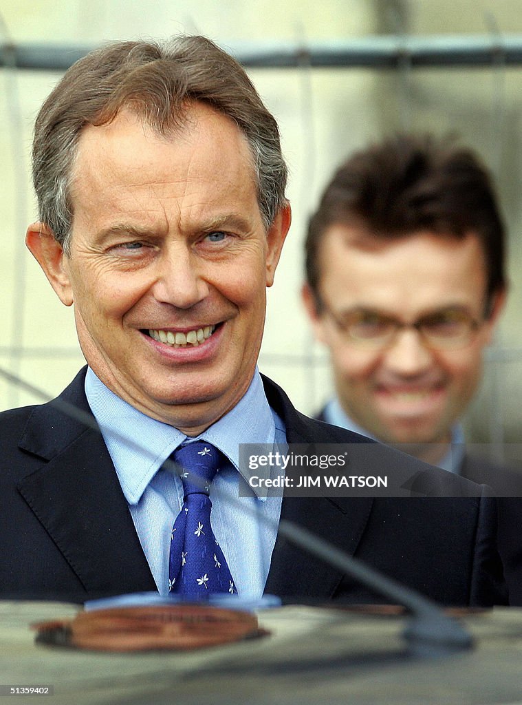 British Prime Minister Tony Blair looks on as he gets in his car