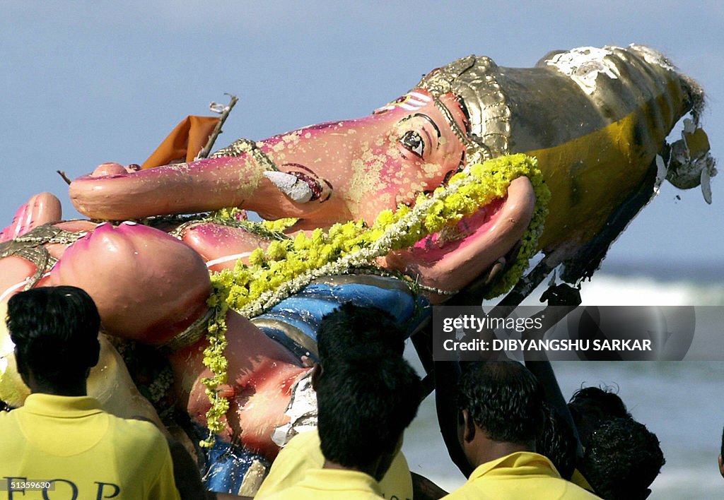 Indian fishermen carry an idol of the el