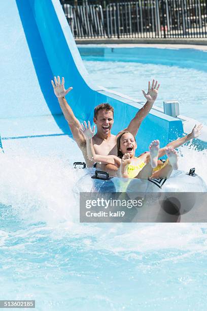 father and daughter on water slide - waterslide bildbanksfoton och bilder