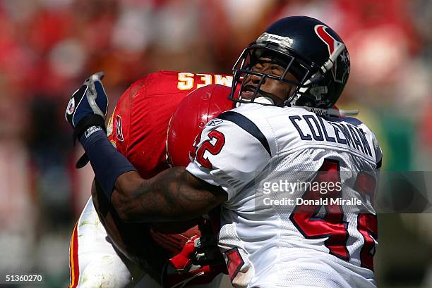 Marcus Coleman of the Houston Texans is hit by runningback Priest Holmes of the Kansas City Chiefs during the 1st half of their NFL game on September...