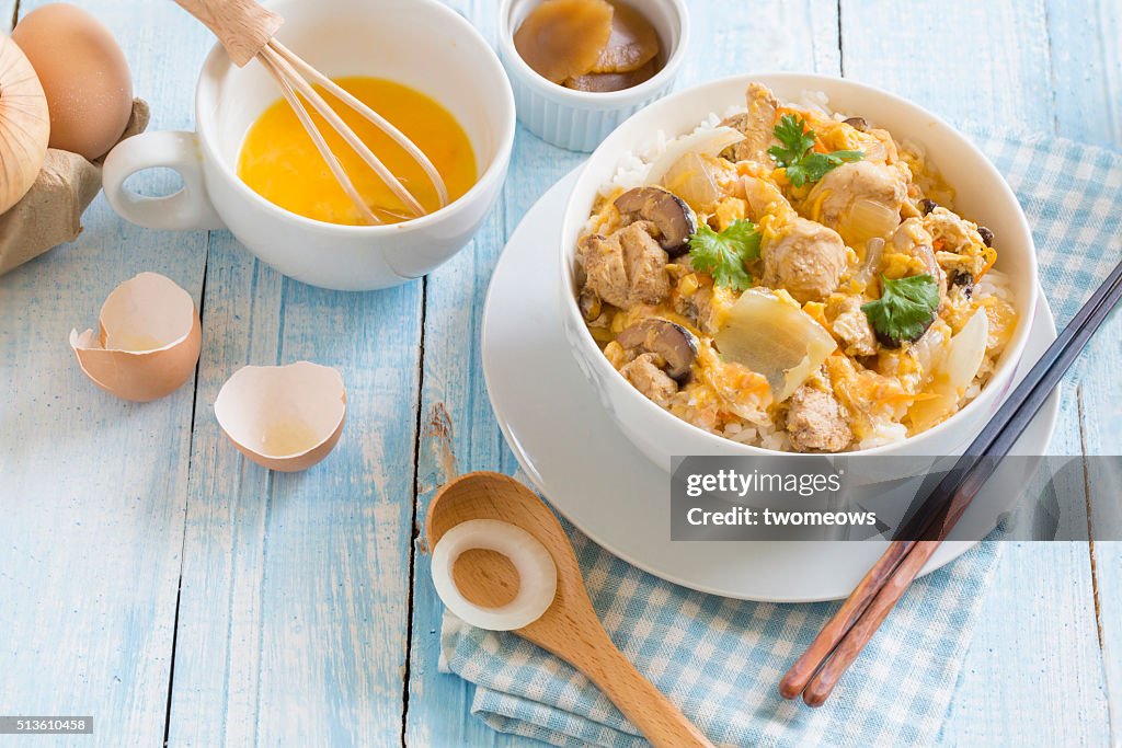 Japanese food Oyako donburi chicken with egg on steamed rice.