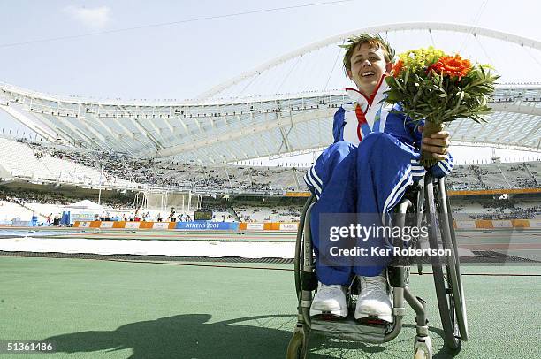 Tanni Grey-Thompson of Great Britain celebrates winning the gold medal in the Womens 400m - T53 Final during the Athens 2004 Paralympic Games at the...