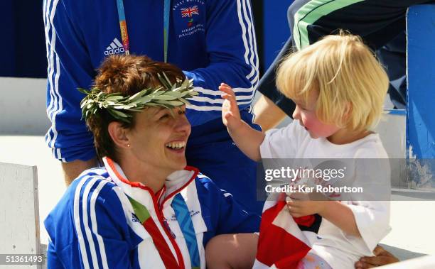 Tanni Grey-Thompson of Great Britain celebrates winning the gold medal in the Womens 400m - T53 Final with her daughter Carys, on September 27,...