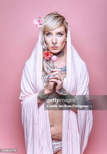 portrait of tattooed model wearing pink shawl - madonna portraits foto e immagini stock