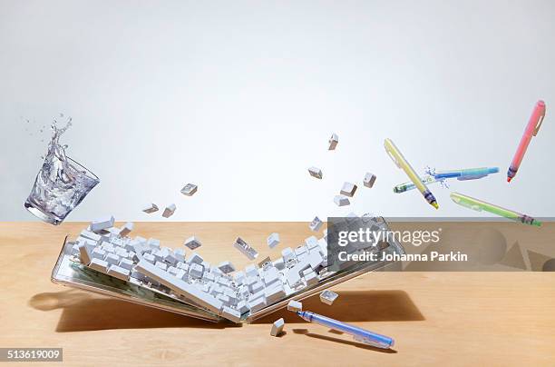 smashed up computer keyboard on office desk - middelgrote groep dingen stockfoto's en -beelden