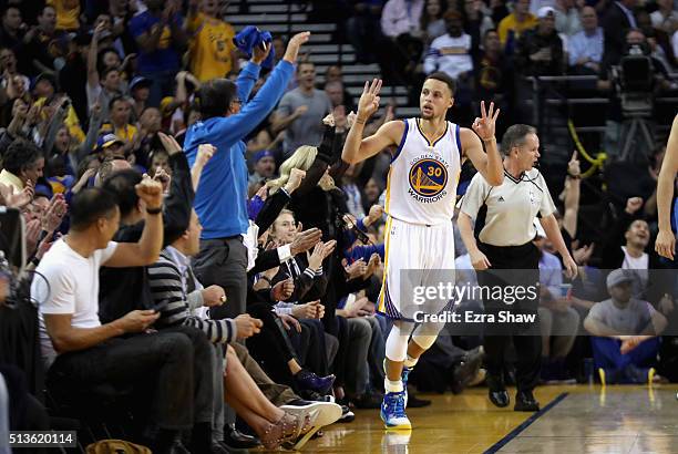 Stephen Curry of the Golden State Warriors reacts after making a three-point basket against the Oklahoma City Thunder at ORACLE Arena on March 3,...