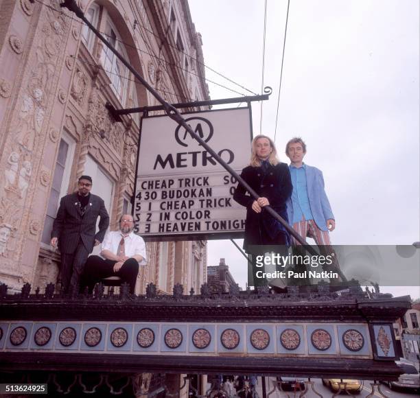 Portrait of American band Cheap Trick posed atop the marquee of the Metro auditorium, Chicago, Illinois, May 1, 1998. Pictured are, from left, Rick...