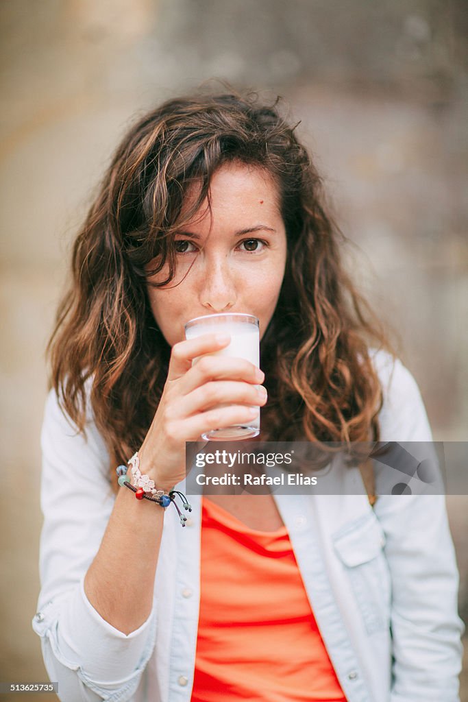Pretty woman drinking milk