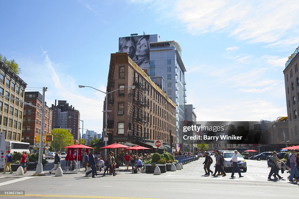 People crossing avenue near triangle building