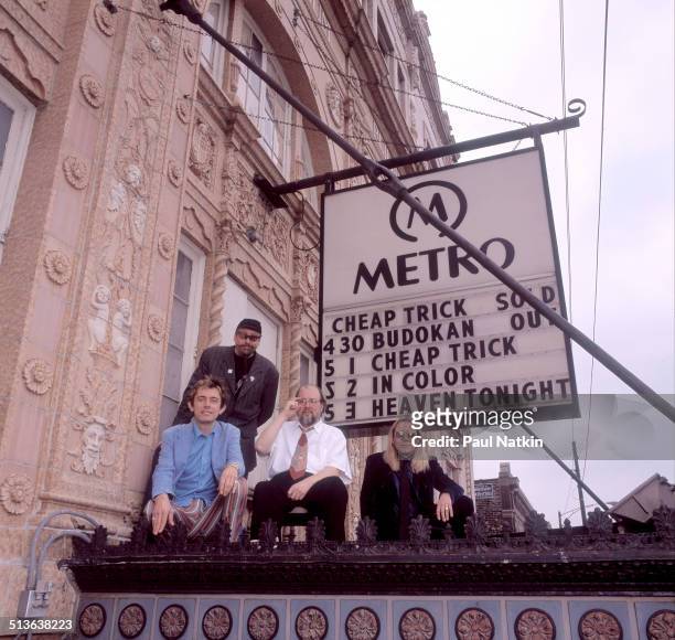 Portrait of American band Cheap Trick posed atop the marquee of the Metro auditorium, Chicago, Illinois, May 1, 1998. Pictured are, from left, Robin...
