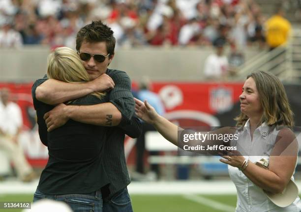 The family of the late Pat Tillman stands on the field for a tribute before the game between the Arizona Cardinals and the New England Patriots at...