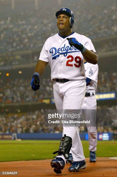 Adrian Beltre of the Los Angeles Dodgers returns to the dugout after hitting a Grand Slam home run in the second inning against the Colorado Rockies...