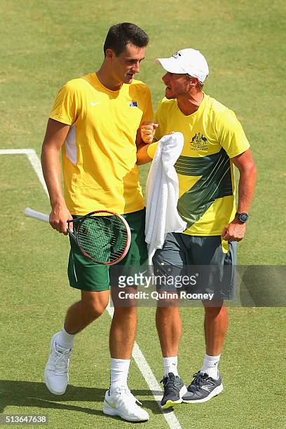 Bernard Tomic of Australia is encouraged by captain Lleyton Hewitt during his match against Jack Sock of the United States during the Davis Cup tie...