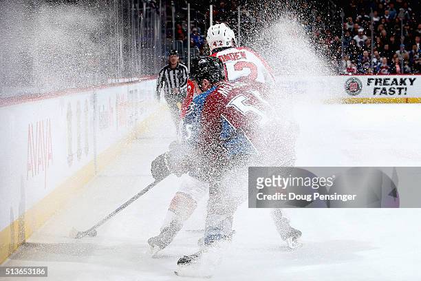 Cody McLeod of the Colorado Avalanche and Quinton Howden of the Florida Panthers spray ice as the pursue the puck at Pepsi Center on March 3, 2016 in...