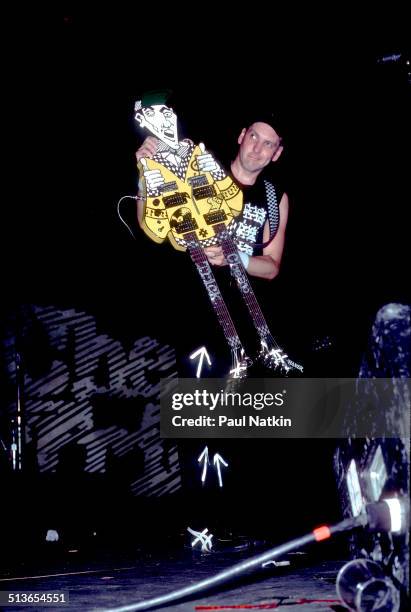 American musician Rick Nielsen plays a double-necked guitar with the band Cheap Trick during a performance onstage, Chicago, Illinois, June 15, 1990.