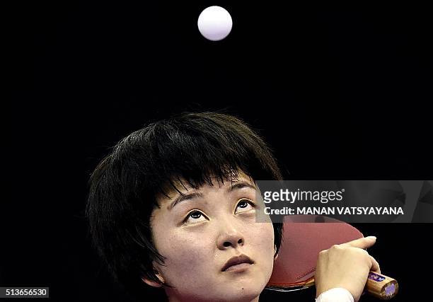 Ri Myong-Sun of North Korea serves against Yu Mengyu of Singapore during their women's singles quarter-final match of the 2016 World Team Table...