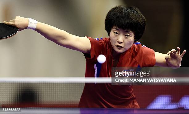 Ri Myong-Sun of North Korea hits a return against Yu Mengyu of Singapore during their women's singles quarter-final match of the 2016 World Team...