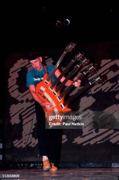 American musician Rick Nielsen plays a five-necked guitar with the band Cheap Trick during a performance onstage, Chicago, Illinois, June 15, 1990.