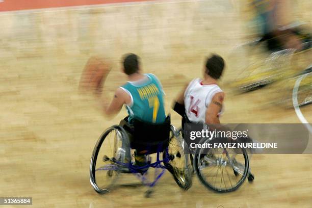 Australia's Shaun Norris dribbles past Canada's Travis Gaertner during the final of the Paralympic wheelchair basketball in the Olympic Indoor Hall...