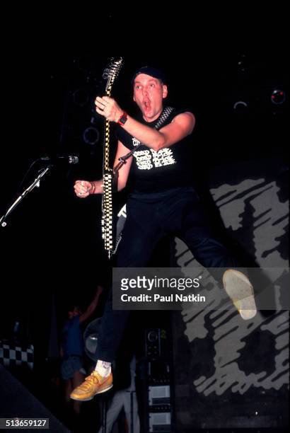 American musician Rick Nielsen plays guitar with the band Cheap Trick during a performance onstage, Chicago, Illinois, June 15, 1990.