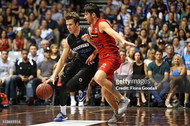 Tom Abercrombie takes the ball up for the Breakers with Damian Martin in defence during game two of the NBL Grand Final series between the New...