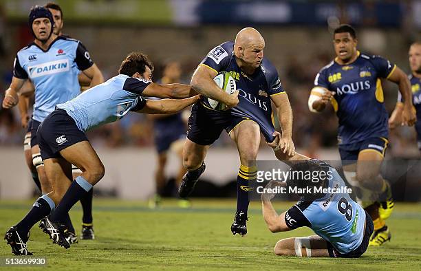 Stephen Moore of the Brumbies is tackled by Nick Phipps and Jed Holloway of the Waratahs during the round two NRL match between the Brumbies and the...