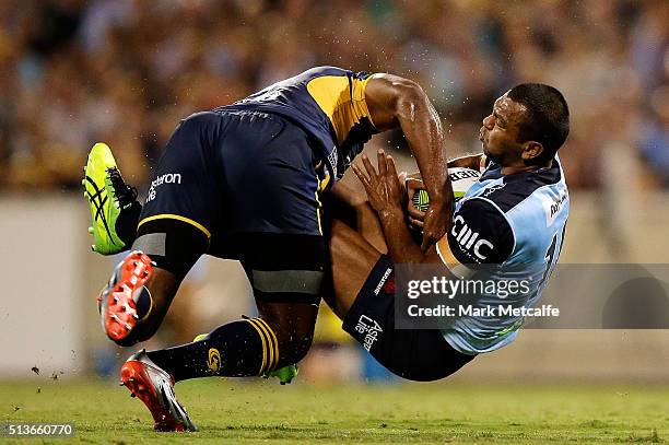 Kurtley Beale of the Waratahs is tackled by Tevita Kuridrani of the Brumbies during the round two NRL match between the Brumbies and the Waratahs at...