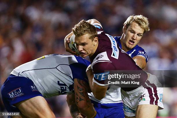 Tom Trbojevic of the Sea Eagles is tackled during the round one NRL match between the Manly Warringah Sea Eagles and the Canterbury Bulldogs at...