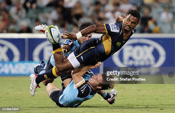 Henry Speight of the Brumbies off loads the ball during the round two NRL match between the Brumbies and the Waratahs at GIO Stadium on March 4, 2016...