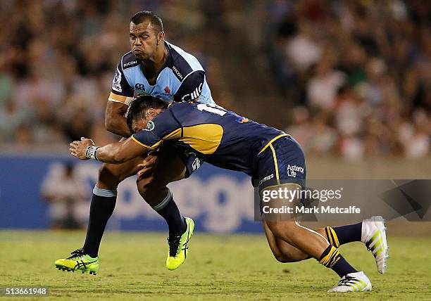 Kurtley Beale of the Waratahs is tackled by Christian Lealiifano of the Brumbies during the round two NRL match between the Brumbies and the Waratahs...