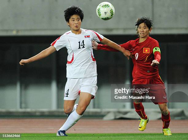 Ju Hyo Sim of North Korea and Tran Thi Thuy Trang of Vietnam compete for the ball during the AFC Women's Olympic Final Qualification Round match...