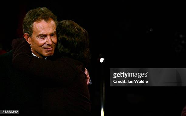Britain's Prime Minister Tony Blair and his wife Cherie are seen after his keynote speech at the Labour Party Annual Conference on September 28, 2004...