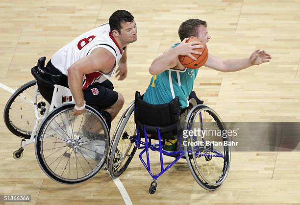 Joey Johnson of Canada collides with Shaun Norris of Australia sending both to the floor in a physical game for the gold medal in wheelchair...